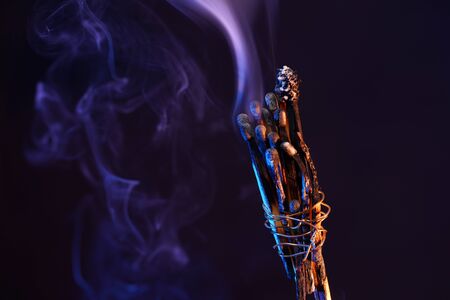 Lit matches and blown out in the studio photographed with colorful foils before the flashesの写真素材