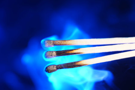 Lit matches and blown out in the studio photographed with colorful foils before the flashes