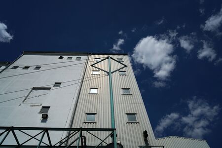 Factory barrels in industrial areas with aluminum as outer cladding photographed in summerの写真素材