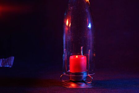 Candle with smoke and flame photographed in the studio with color foils before the flashesの写真素材