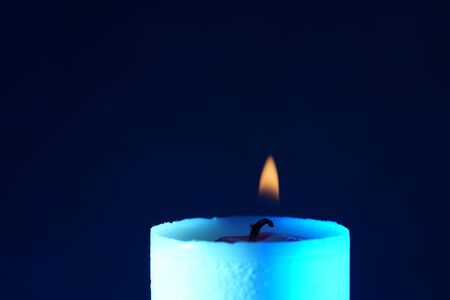 Candle with smoke and flame photographed in the studio with color foils before the flashesの写真素材