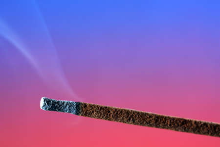 Multi colored smoke from an incense stick with color foils Photographed in front of the flash in the studioの写真素材