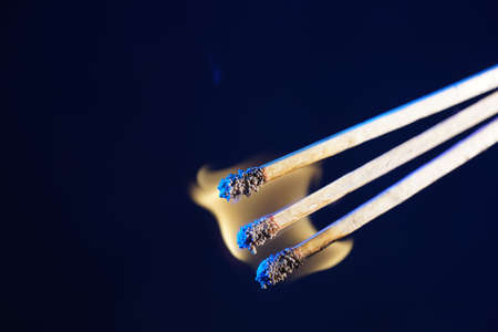 Lit matches and blown out in the studio photographed with colorful foils before the flashesの写真素材