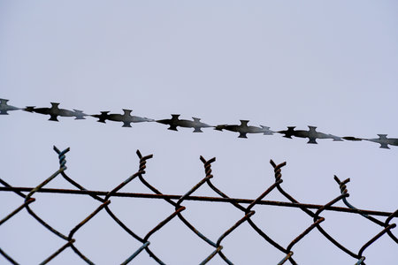 Fence wire photographed outdoors in the best of daylightの写真素材