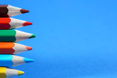 Colorful crayons, pencils with plain paper as a background with structureの写真素材