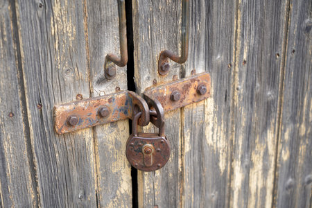 Old padlock with rust but fully functional photographed in the studio