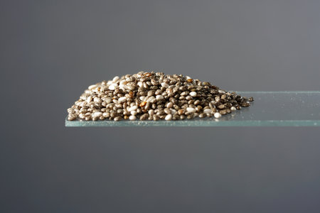 Chia seeds photographed in the studio in detail against black backgroundの写真素材