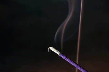 Smoke from an incense stick with color foils Photographed in the studioの写真素材