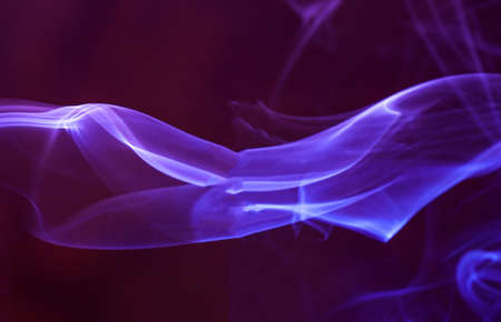 Smoke from an incense stick with color foils Photographed in the studioの写真素材