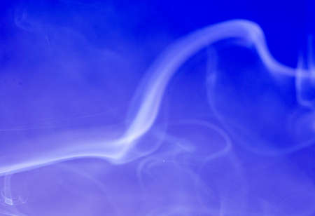 Smoke from an incense stick with color foils Photographed in the studioの写真素材