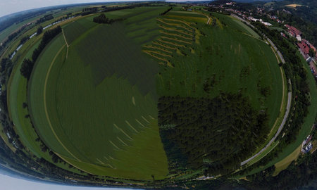 Spherical abstract panoramic aerial view in a field with fantastic beautiful clouds and curvature of...