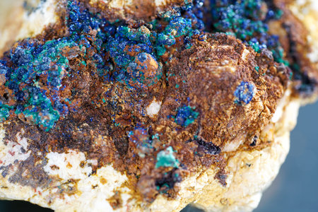 Quartz with mineral inclusions in the studio in front of black background photographed in marco mode
