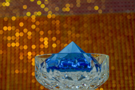 Glass made of crystal-like materials photographed in the studio with colorful background