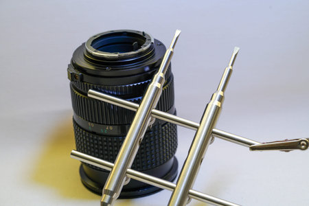Clean and disassemble the lens for photography into its component parts
