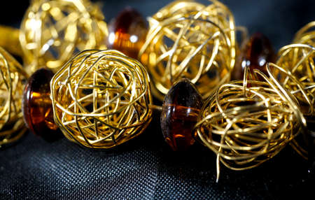 Jewelry made of fake gold and silver and artificial gemstones photographed in the studioの写真素材