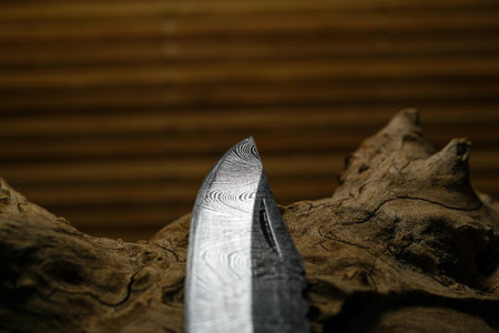 Damask Hand-forged knife made of several layers of steel with an exclusive pattern photographed in...