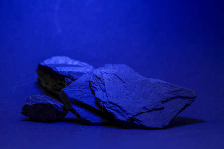 Slate, stone splinter, wood splinter, shingle is a collective term for different tectonically deformed and also metamorphic sedimentary rocks photographed in the studioの写真素材