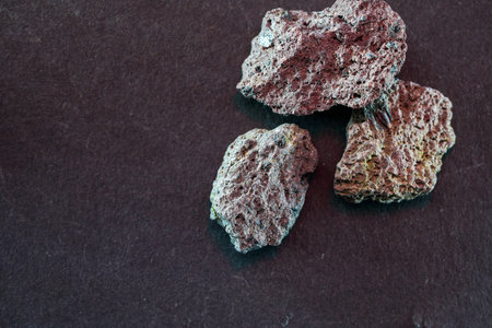 Granites are coarsely crystalline plutonic rocks rich in quartz and feldspar, but also contain dark...