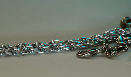 Silver chain for costume jewelry as a background image with copy space photographed in the studio