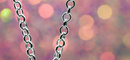 Silver chain for costume jewelry as a background image with copy space photographed in the studioの写真素材