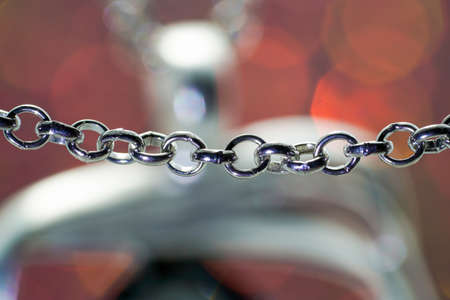 Silver chain for costume jewelry as a background image with copy space photographed in the studioの写真素材