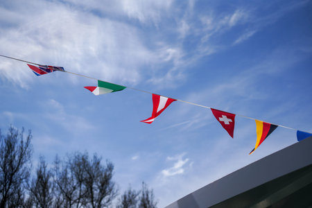 flag flies against a blue white sky on a summer day in Bavaria