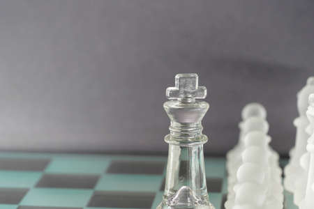 Chess with game pieces made of glass, queen, king, pawn and game board made of glass in black and whiteの写真素材