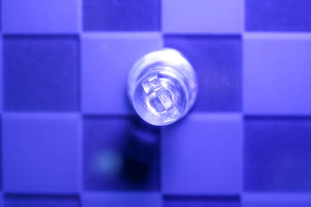 Chess with game pieces made of glass, queen, king, pawn and game board made of glass in black and whiteの写真素材