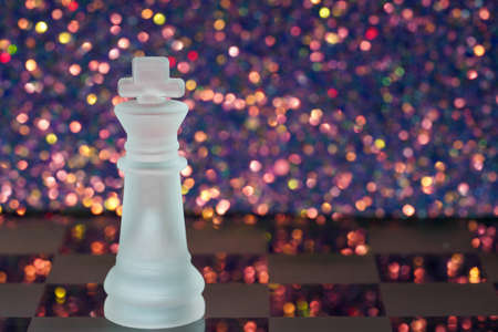 Chess with game pieces made of glass, queen, king, pawn and game board made of glass in black and whiteの写真素材