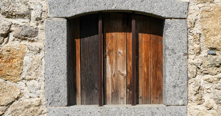 Aged wooden window with glazing and partially weathered in rustic homesの写真素材