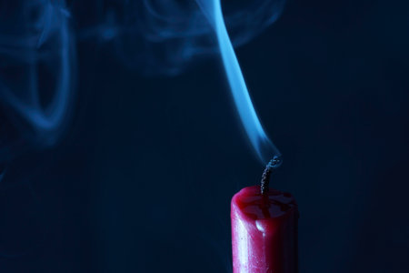 candle with smoke and flame photographed in the studio with color foils before the flashesの写真素材
