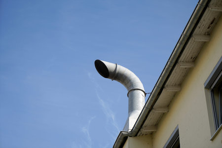 The pipe of the heating system on the roof of the house.