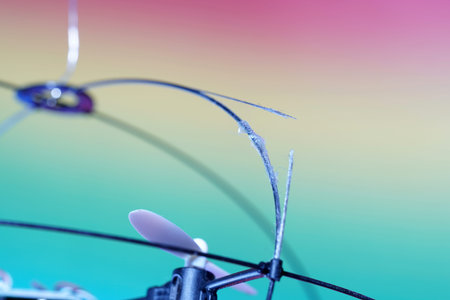 Broken TV antenna on a multicolored background close-up