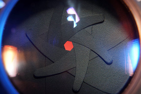 Camera lens with the reflection of a human body. The concept of professional photography.の写真素材