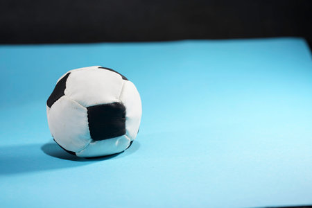 Black and white soccer ball on a blue background. Copyspace.の写真素材