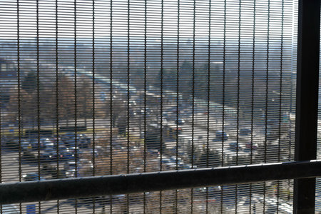 The window of the building is seen through the blinds in the cityの写真素材