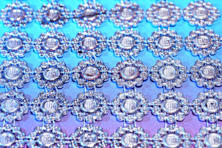 Macro shot of a blue fabric with a pattern of beads.