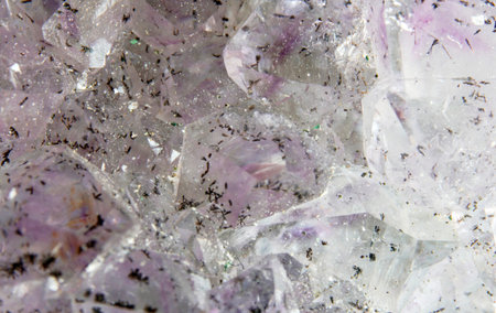 macro shooting of natural mineral rock specimen - piece of amethyst gemstone on white background