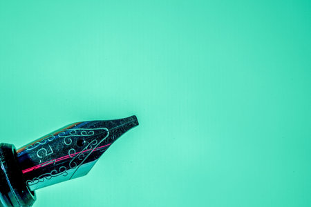 Vintage fountain pen on a green background with space for text.