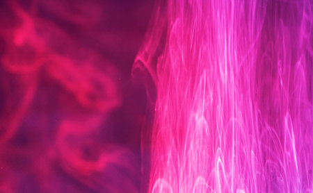 abstract pink and purple smoke on a black background in neon light