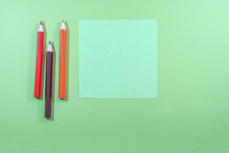 Colorful pencils on green background with copy space. top viewの写真素材
