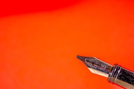 Fountain pen on a red background with space for your text.の写真素材