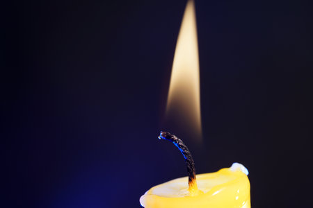 Burning candle on a dark background. Shallow depth of field.の写真素材