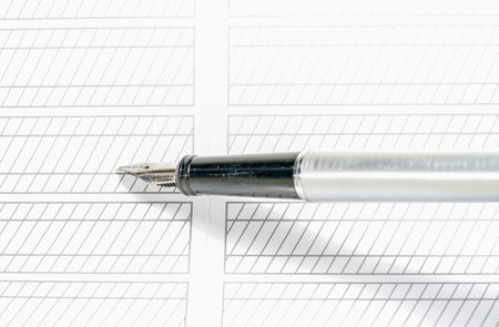 Pen on the paper, close-up shot, isolated on white
