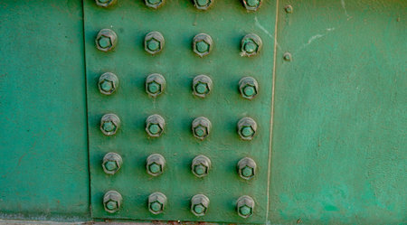 Green metal door with rivets and bolts close-up. Backgroundの写真素材
