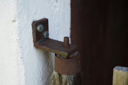 Old rusty door handle with wooden handle, closeup of photo.