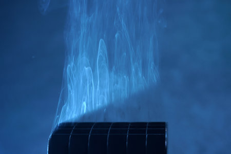 Air-conditioner in smoke on a blue background close-upの写真素材