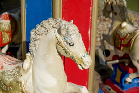 Carousel horse in the amusement park, close-up of photoの写真素材