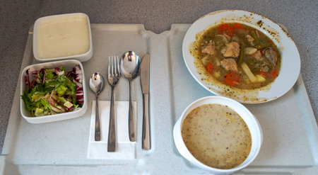 Vegetable soup with meat and vegetables on a white plate.の写真素材