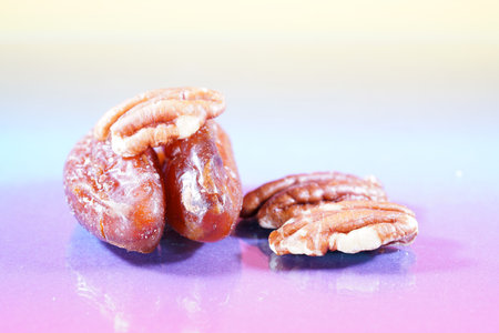 Pecan nuts on a blue background, closeup of photoの写真素材
